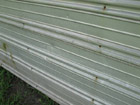 Wind damage to the metal siding of a shed in Florida