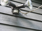 Hardboard siding damaged in Florida when power drop yanked out